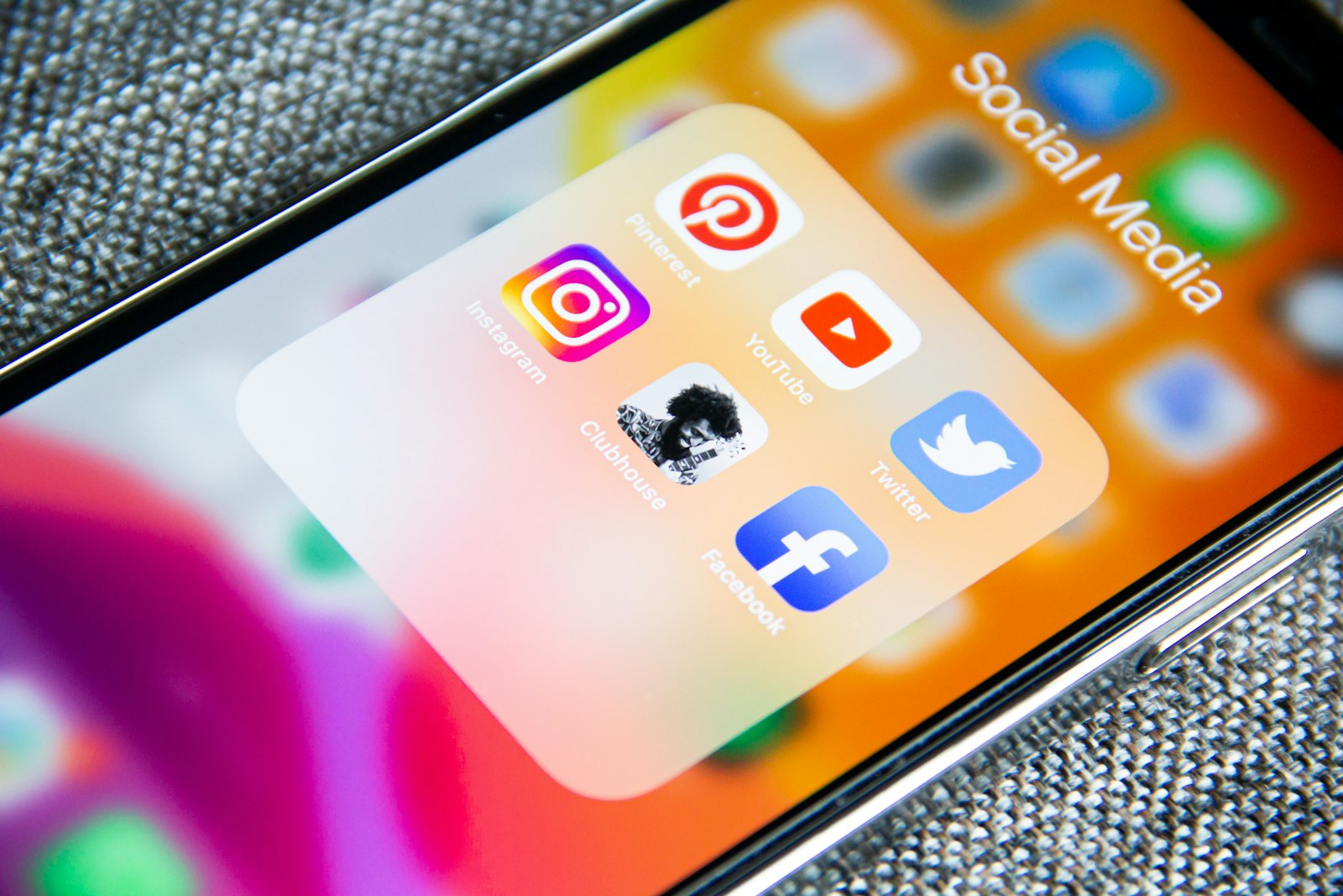 Phone screen with a folder of social media apps